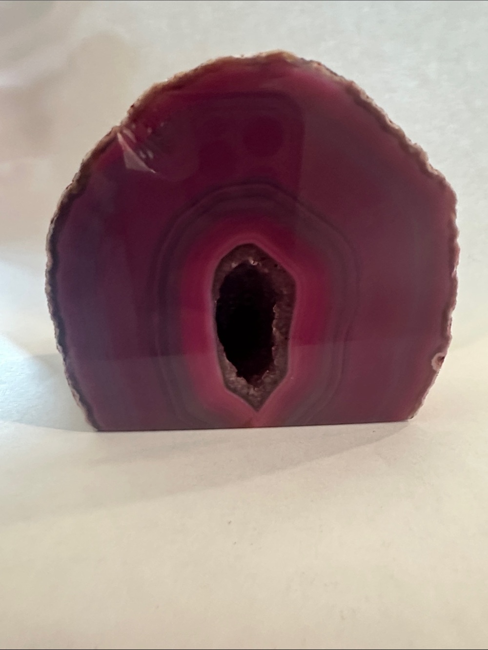 PolishesDyed Purple Agate Geode with sparkling center crystal cavity.